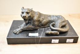 A cast patinated metal study of a leopard resting upon a marble base, measuring 27cm x 14cm, no