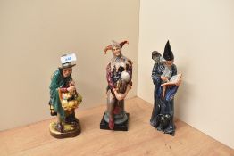A group of three Royal Doutlon figures comprising 'The Mask Seller' HN 2103, 'The Jester' HN 2016