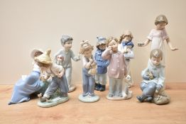 A group of nine Nao by Lladro porcelain figures/figurines including 'Ready for an Excursion'