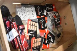 A box of shop stock Fender parts including pick up selector switches, strap buttons, jack outputs