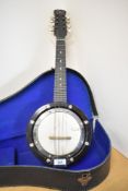 An early 20th century banjo mandolin with label for John Grey and Sons, in shaped case