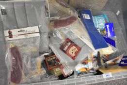 A box of various parts and accessories, including woodwind related, cleaners, violin shoulder