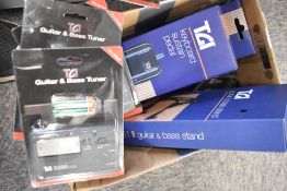 A small selection of TGI accessories including keyboard sustain pedal and guitar stand