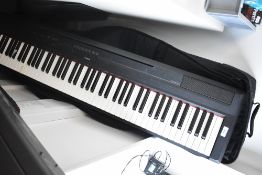 A Yamaha digital piano - P115, with manual, power supply and padded gig bag, sold with fault, bottom