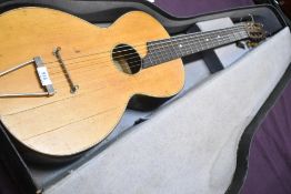 An antique Parlour guitar having later tailpiece and steel strings, no visible label, in card case