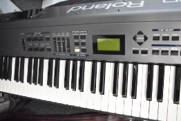 A Roland RD-700 keyboard, with folding stand, power supply, foot pedal and padded gig bag, in nice