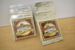 Eleven sets of Ernie Ball Earthwood acoustic strings, 7 x 2006 Extra Light (10s) and 4 x 2010 12