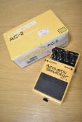 A boxed Boss AC-2 acoustic simulator guitar effects pedal