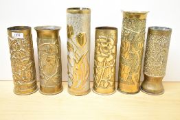A group of six French and German World War I brass Trench Art shell cases, embossed and hand-