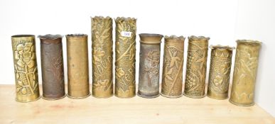 A pair of good French World War I brass 75DEC Trench Art shell cases, decorated in low relief with