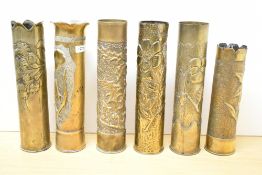 A group of six French World War I brass Trench Art shell cases, embossed and hand-worked foliate