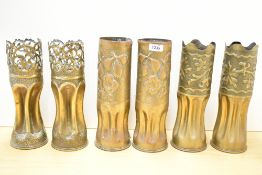 A pair of British World War I 18 pounder II Trench Art shell cases, the surmounts finely pierced