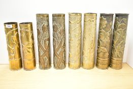Four pairs of French World War I brass Trench Art shell cases, each embossed in relief with