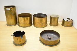A group of seven brass World War I shell cases, one with good hand engraved floral decoration, one