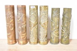 Three pairs of French 75Dec World War I brass Trench Art shell cases, one pair finely embossed in