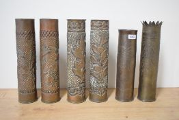 Two pairs of World War I French Trench Art shell cases, each with foliate designs and punched