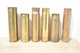 A group of six brass World War shell cases, all undecorated but three with attempts at shaped