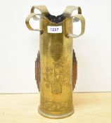 A British World War I brass Trench Art shell case, having an unusual shaped and 'crowned' surmound