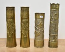 A pair of large World War I brass 'Trench Art' shell cases, with embossed fluting, engraved pendants