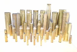 A collection of World War I & II brass artillery shell and ammunition casings, various French 75DEC,