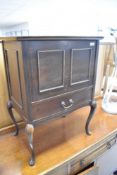 An early 20th Century mahogany sewing cabinet having lift lid section over drawer, on cabriole legs,