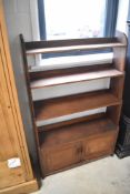 A 19th Century Arts & Crafts mahogany waterfall bookshelf with double cupboard under, approx 76 x