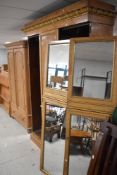 A 19th Century birds eye maple double mirror door wardrobe having giltwood detailing, dimensions