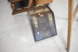 A Victorian oak and brass coal purdonium