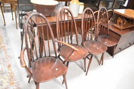 A set of four (three plus one) dark stained Ercol hoop and stick back chairs
