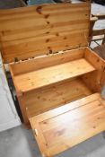 A vintage pine bedding/storage box having lift drop and drop front, width approx. 95cm