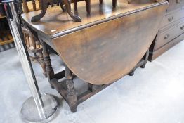 A period style oak gateleg dining table, width approx. 120cm
