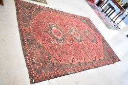 A traditional , Persian Shiraz rug, having red ground, approx. 270 x 190cm