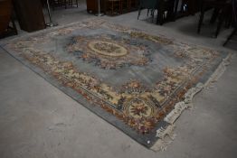 A large traditional Chinese carpet square, having light blue ground with floral patterns , approx.