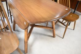 A mid stain Ercol colonial style drop leaf dining table, width approx. 113cm