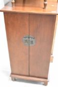 A modern mahogany CD cabinet having Oriental style handle