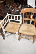 A 19th Century corner chair having painted bobbin frame and a spindle back kitchen chair