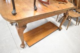 A late 19th or early 20th Century oak extending wind out dining table , having rounded edge and