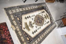 An Indian rug, bearing label for Oriental Carpet Factory, wool and silk, approx 6ft x 4ft