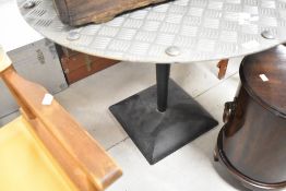 A checker plate garden table of circular form, diameter approx. 92cm