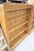 A modern pine bookshelf, approx W126 H137cm