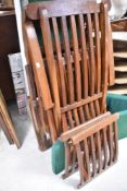 Two teak garden chairs, in the steamer style, with cushions