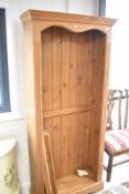 A natural pine tall bookcase, dimensions approx. H199 W89 D32cm