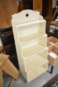 A vintage painted waterfall bookshelf of small proportions, height approx. 113cm, width 46cm