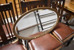 A gilt frame oval wall mirror, approx. 75 x 43cm