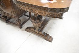 A carved oak 'lees' drawer leaf table