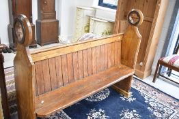 A Victorian Gothic stained pine pew, width approx. 153cm