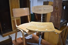 A vintage swivel ply wood office chair and a bent ply school chair