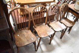 A set of four traditional elm hoop and stick back kitchen chairs