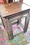 An oriental style nest of three mahogany tables