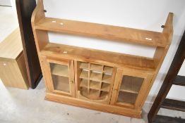 A stripped pine glazed wall cabinet, width approx. 98cm